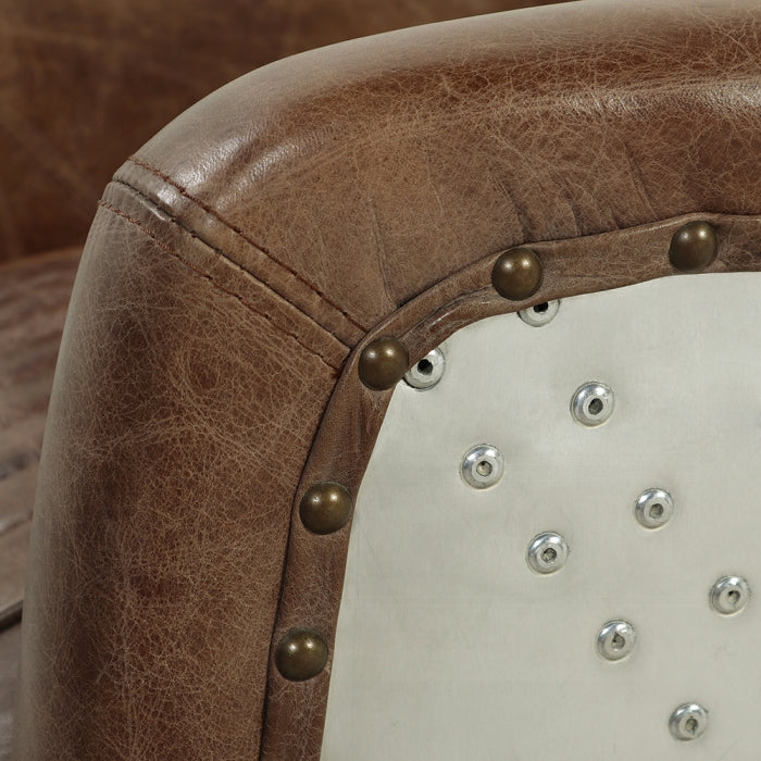 leather arm corner showing the leather and the aluminum close up meeting help ogether with pins and joints 