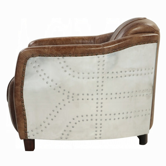 white background leather chair with arms brown leather matching through out aluminum siding wrapping the outer part of the arms leather pinned stitching stripped going down the middle and wooden square feet pegs 
