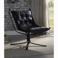 Black leather chair in a room with a brick wall and window.