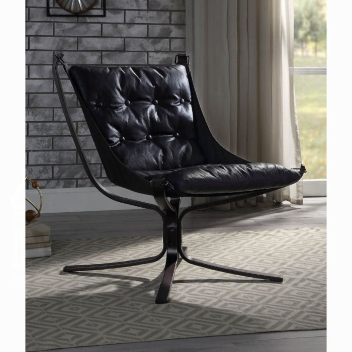 Black leather chair in a room with a brick wall and window.