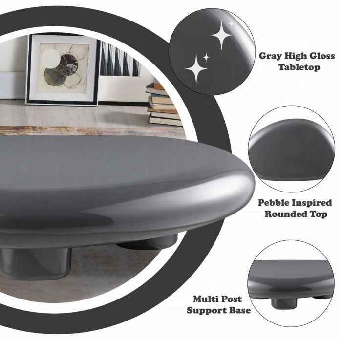 Gray high gloss table with pebble-inspired rounded top and multi-post support base, shown in a room setting.