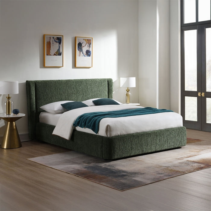 dark forest green bed frame fabric covered all around in the same color staged in a bedroom setting with night stands lamps pictures rugs and a window with pillows and blankets 