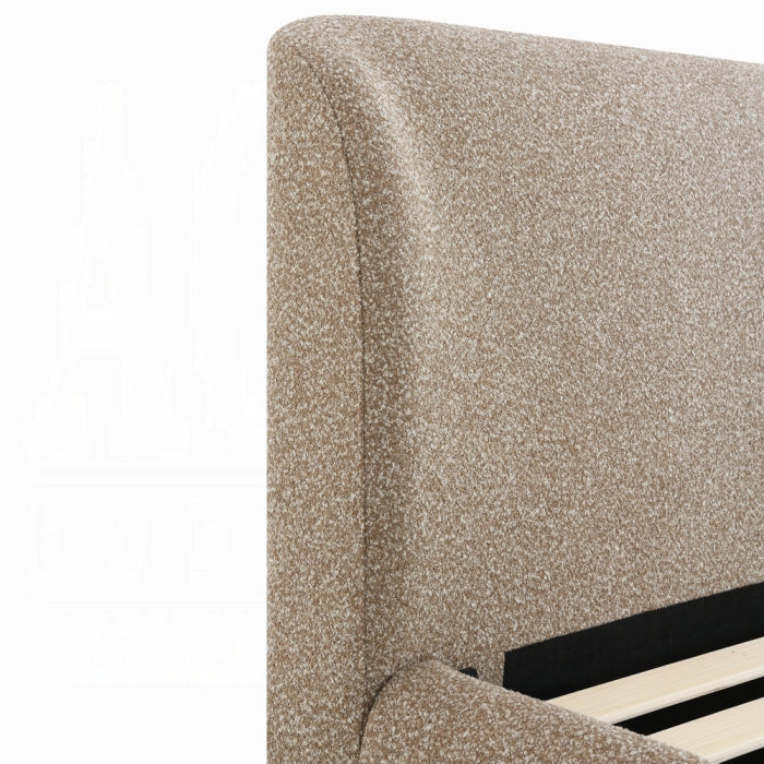 white background corner of the erica bedframe showing a slight inword curve at the ends of the headboards in the light brown color fabric 