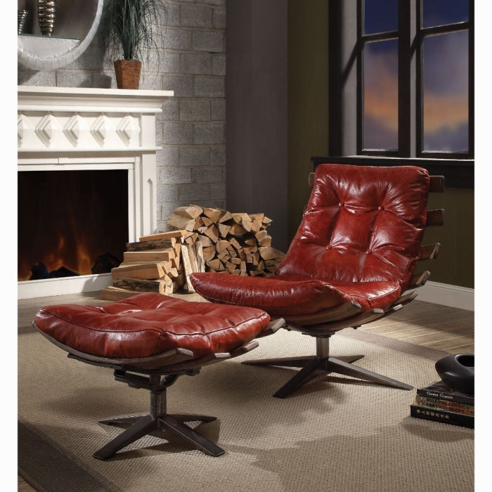 Red leather chair and ottoman in a living room with a fireplace and window.