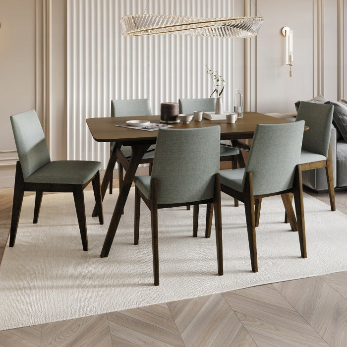 grey fabric dinning chair with no arms and wood leg base four legs  staged with table in living room setting cups plates rug lighting 