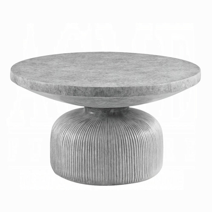 hour glass shape concrete appearance coffee table with ridged lines at the bottom and a round flat top white background