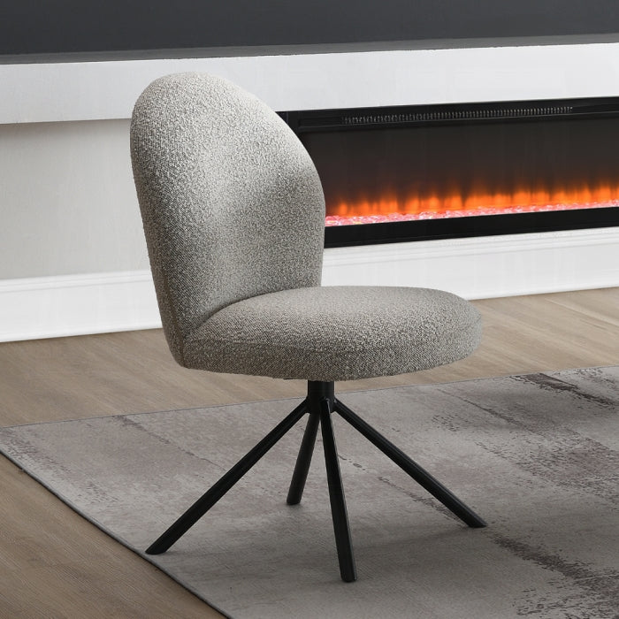 boucle grey chair no arms just the back with black legs staged infront of a fireplace and grey fabric 