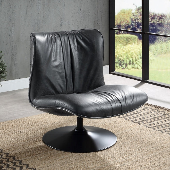 Black leather swivel chair in a room with large windows and greenery outside