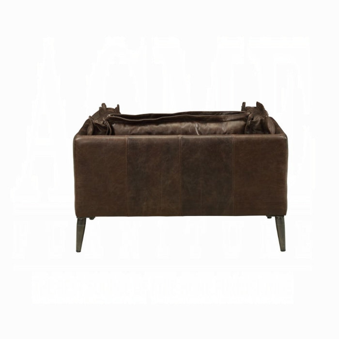 white background dark brown leather chair with plush pillows all around matching leather through out the chair metal legs