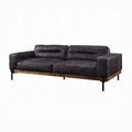 Black leather sofa with wooden legs on a white background
