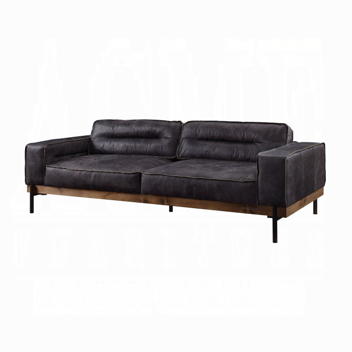 Black leather sofa with wooden legs on a white background