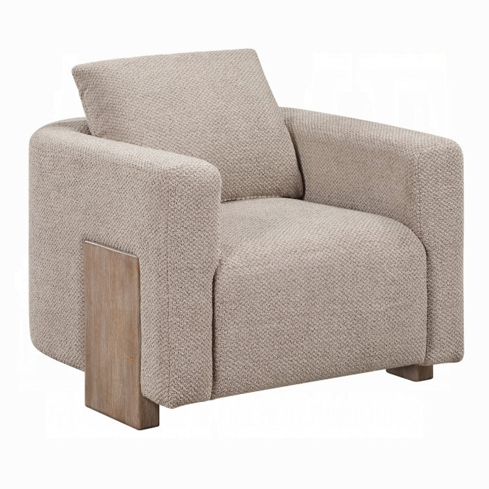 Beige armchair with wooden legs on a white background
