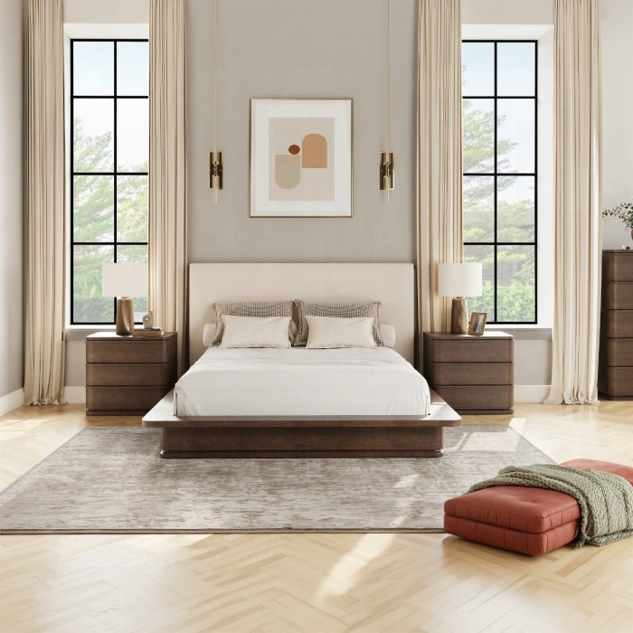 Modern bedroom with wooden bed, nightstands, and artwork on a neutral wall.