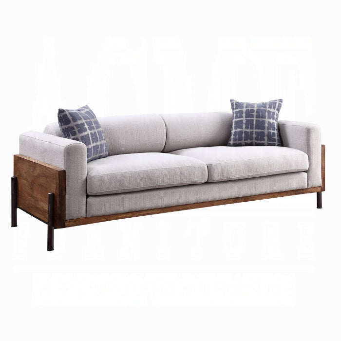 Gray sofa with wooden frame and plaid cushions on a white background