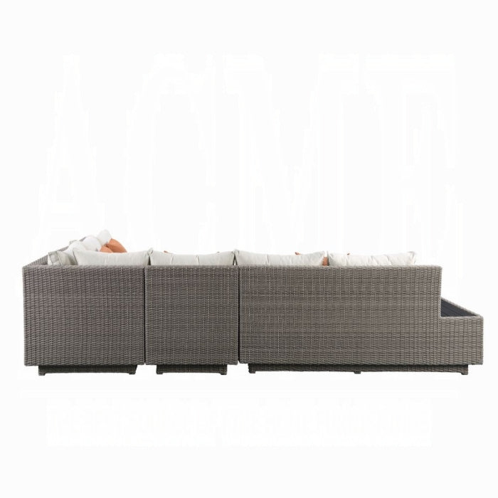 Outdoor sofa set with wicker frame and white cushions on a white background