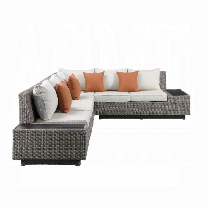 Sectional outdoor sofa with wicker frame and cushions on a white background