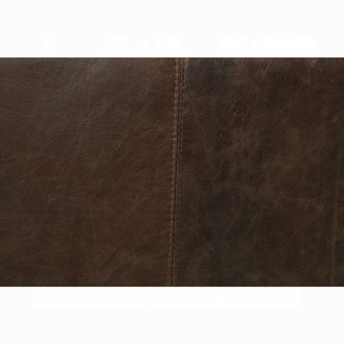 Close-up of brown leather texture with a visible seam.